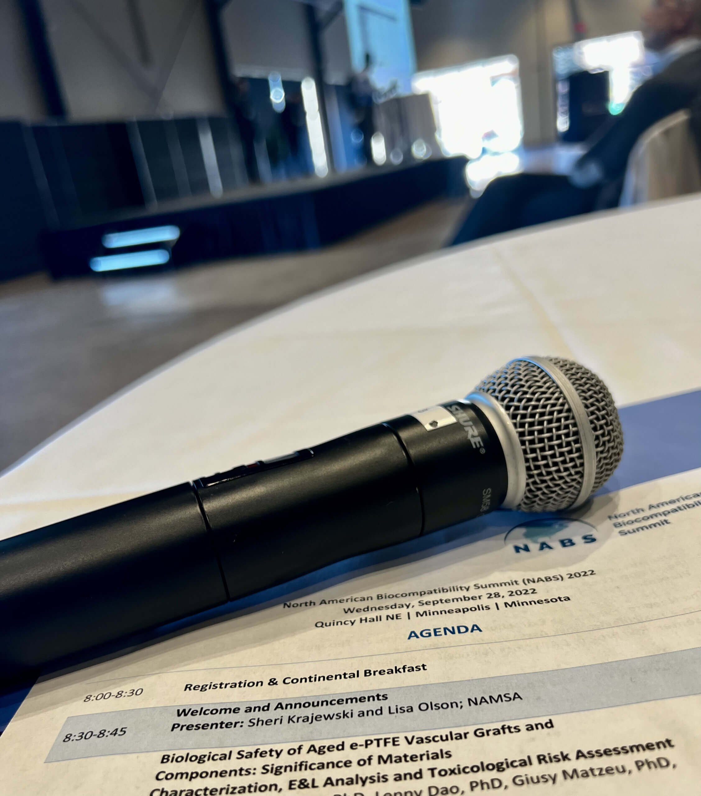 Microphone laying on top of an event agenda